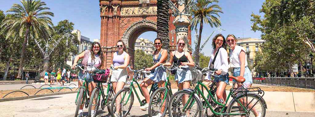Girls on a Barcelona bike tour at the Arc de Triomf in Barcelona.